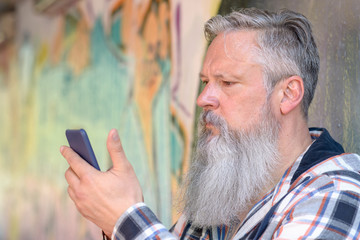 Mature attractive grey-haired man with a beard