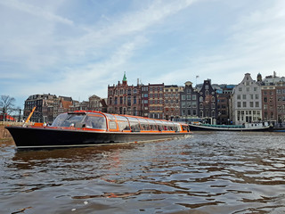 Fototapeta premium Cruising through Amsterdam canals in the Netherlands
