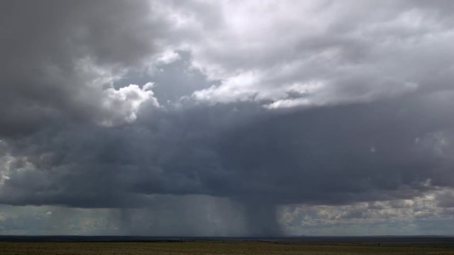 Rainstorm advancing over desert, time lapse