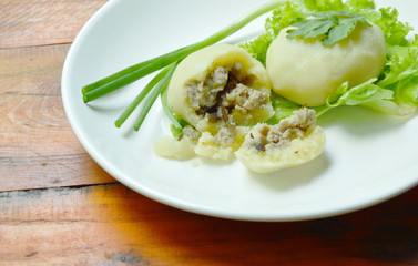mashed steamed potato stuffed fried minced pork and mushroom on white plate