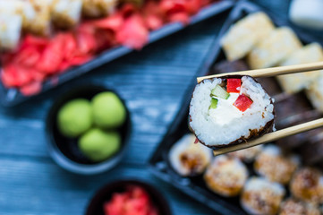 Sushi set: sushi roll with salmon and sushi roll with smoked eel, selective focus.