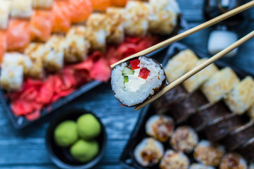 Sushi set: sushi roll with salmon and sushi roll with smoked eel, selective focus.