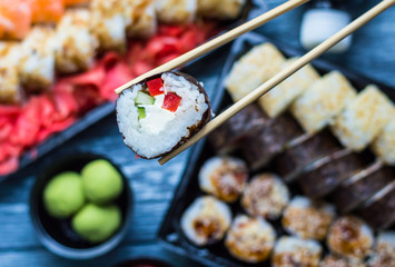 Sushi set: sushi roll with salmon and sushi roll with smoked eel, selective focus.