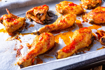 Rustic backed chicken wings,legs on baking tray