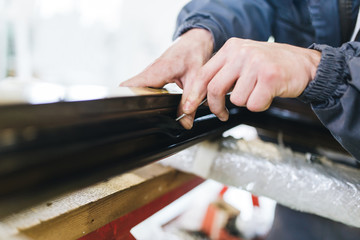 Manual worker assembling PVC doors and windows. Manufacturing jobs. Selective focus. Factory for aluminum and PVC windows and doors production.