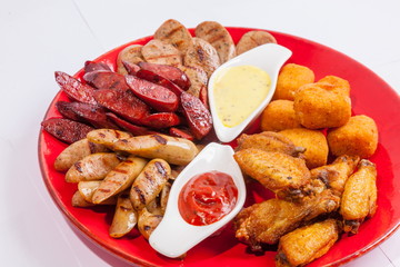 Grilled sausages on a plate with sauce