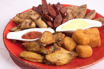 Grilled sausages on a plate with sauce