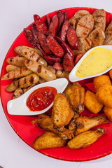 Grilled sausages on a plate with sauce