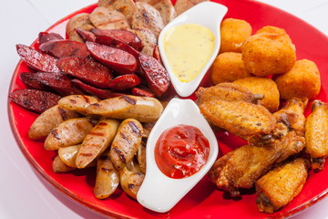 Grilled sausages on a plate with sauce