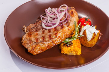 Steak on brown plate