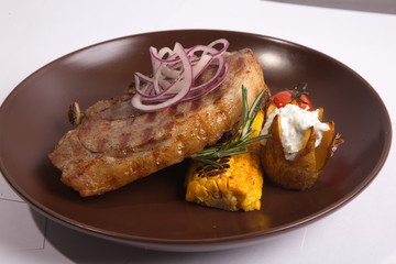 Steak on brown plate
