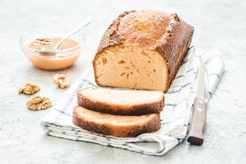 Caramel cheesecake loaf bread on light concrete background. Selective focus, space for text.