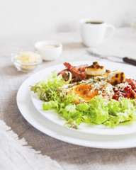Breakfast salad with poached egg. Close up. Selective focus.