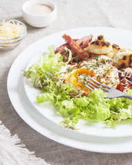 Delicious Breakfast-poached egg, salad, cheese, grilled bread. Vertical. Selective focus.