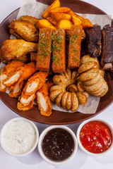 Grilled sausages on a plate with sauce