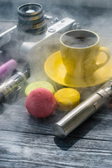 Still life with e-cig and jiuce on the wooden background
