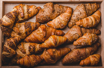 Mix of golden croissants on wood