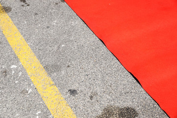 Fototapeta premium Red carpet entrance detail on asphalt road