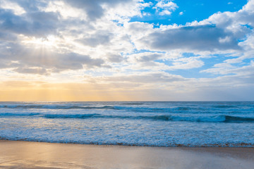 Seascape - ocean waves and sun rays. Tranquil scenic view.
