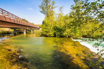 Fototapeta na wymiar Countryside landscape, waterfall and wooden bridge on Mreznica river in Belavici, Croatia 