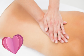 Woman receiving back massage at spa center against heart