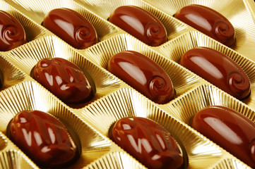 chocolate candies in a gold gift box