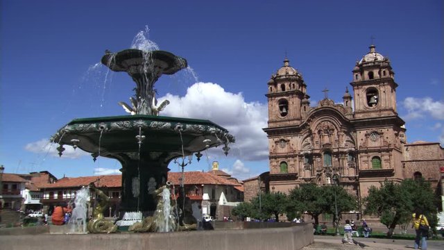 Fountain in the Plaza de Armas and the Church of La Compania in Cusco, Peru