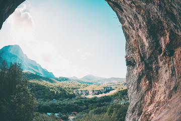 A girl climbs the rock.