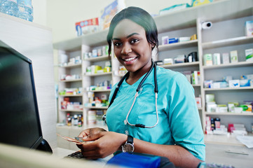 African american pharmacist cashier working in drugstore at hospital pharmacy. African healthcare.