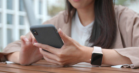 Woman use of smart phone in outdoor cafe