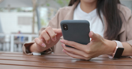 Woman use of mobile phone in cafe