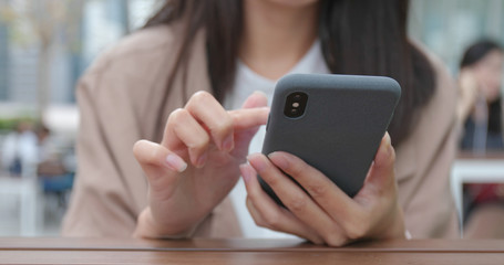 Business woman using mobile phone at outdoor coffee shop