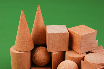 wooden geometric shapes on a green background