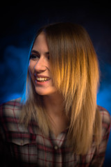 Naklejka premium portrait smiling girl on blue background in studio
