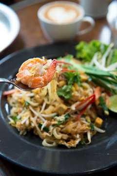 Fried noodle Thai style with prawns, selective focus close up