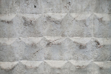 Old soviet concrete fencing with cracked surface close-up. Background image of grunge fence of unusual design. Urban white durable wall.