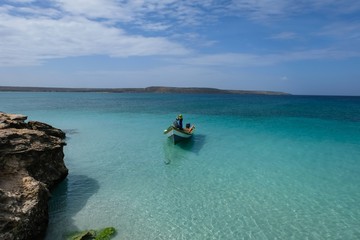 Tropical seascape with a boat anchored next to Cubagua island (Venezuela).