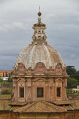 The dome of Santi Luca e Martina in Rome with cloudy weather