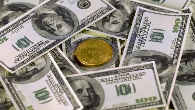 Bitcoin btc bit-coin lie on hundred-dollar bills of United States. Bit-coin lie on Franklin's face. Rotation. Mining. Cryptocurrency. Economy. Cyberspace. Background.