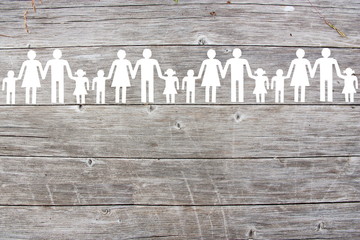 Paper white families on wooden background