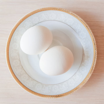 Two white eggs on a plate