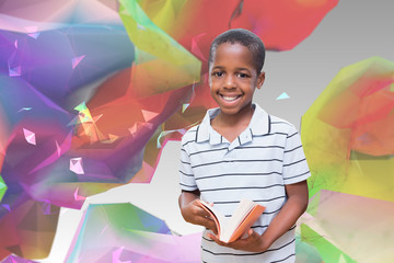 happy pupil with book against colourful abstract design