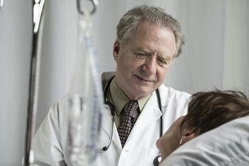 Doctor talking with a patient in hospital room