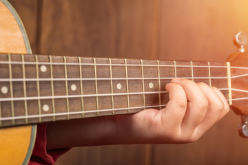 Obraz premium Close up finger Little Girl playing ukulele.