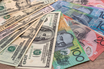 Australian and american dollar banknotes on wooden table