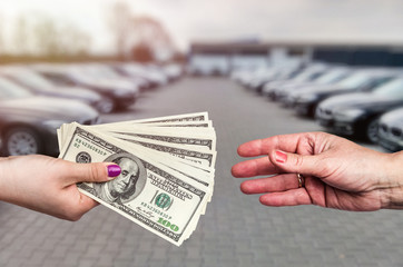 'Buying car' conception, dollar deal between female hands