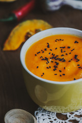 Homemade vegetable soup with pumpkin with cream and black sesame, top view