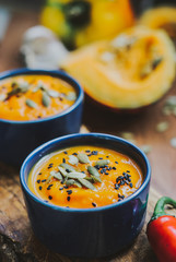 Homemade vegetable soup with pumpkin with cream and black sesame, pumpkin seeds
