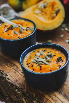 Homemade vegetable soup with pumpkin with cream and black sesame, top view with copy space