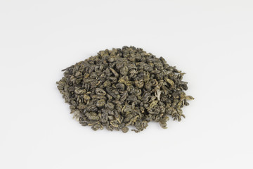 Heap of green gunpowder tea pellets on white background